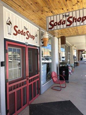 Signs for the soda shop. Has a variety of treats featuring blue bell. A not for profit that benefits the city.