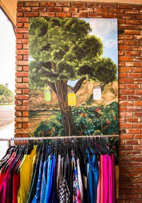 Entrance with clothing rack and artwork of founding of store