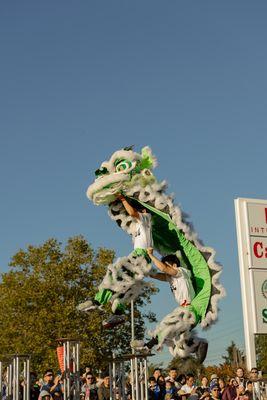 Acrobatic lion dance performance on high poles