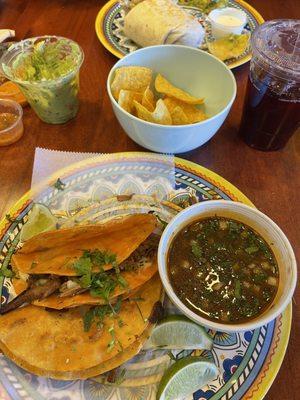 This is the Tacos Birria, shrimp Burritos, Guacamole with Chips, cucumber and lime drink, and hibiscus.