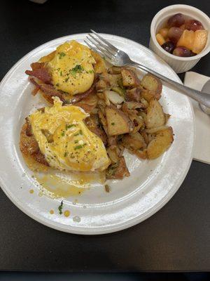 Eggs Benedict custom made with regular bacon (in place of Canadian bacon), and extra hollandaise sauce served with home fries. Outstanding!