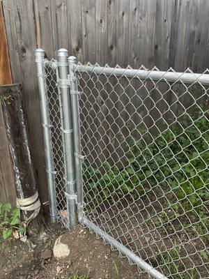 Side Gate. Special care taken with a gate over a drain ditch. Rocks were added to keep the small dogs inside.