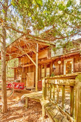 Cabin back porch, deck with porch swing, hammocks, seating areas & chiminea. Over looks dry creek bed.