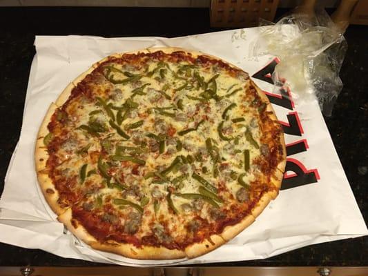 Carry out sausage and green pepper pizza. Parent's treat and choice!