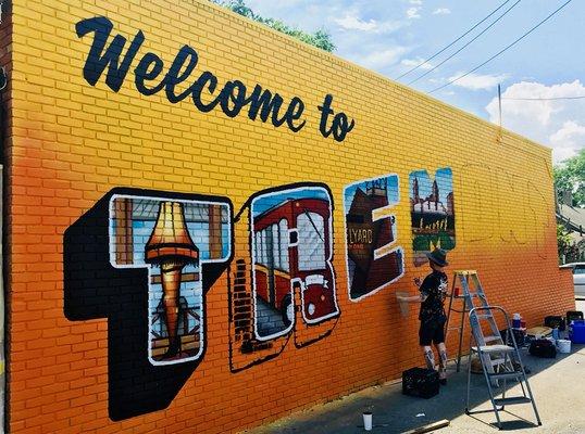 New mural being painted on the side of the store!