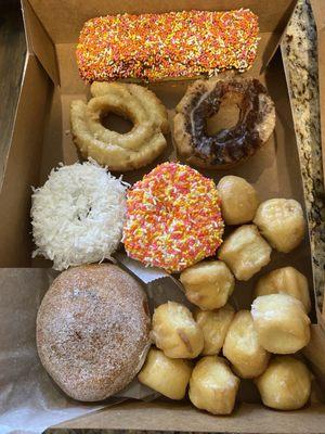 clockwise- choc. long John, cinnamon old fashion, donut holes, sugared jelly, coconut vanilla cake, glazed old fashion, vanilla sprinkle