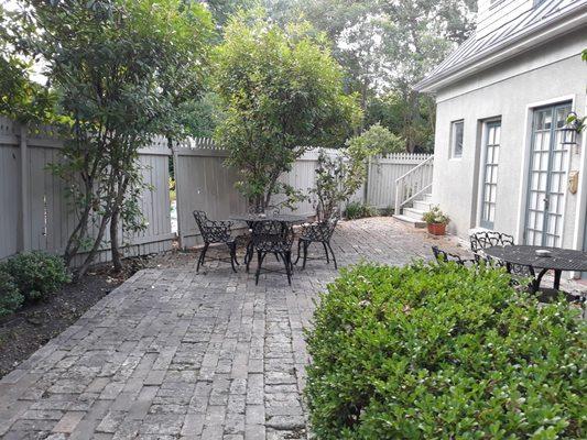 Courtyard. Stairs in back lead up to 2nd floor rooms. Pool on other side of fence.