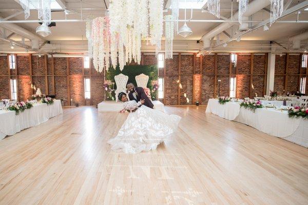 Floral Chandeliers in ceiling with White Royalty Throne trimmed in gold on Boxwood Backdrop