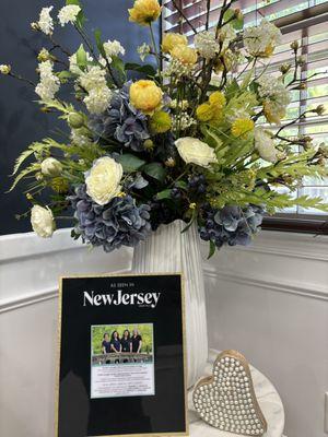 An image of Flowers next a portrait of CEO Dr. Jayshree Sawhney and  her colleagues