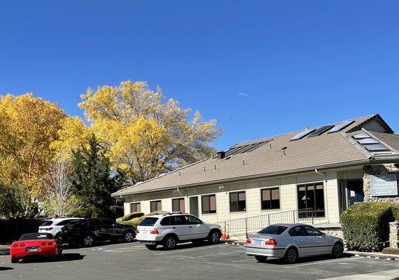 Wow! Parking and nature ? Ample spaces and these beautiful trees make the perfect backdrop to the building.   What a treat!!