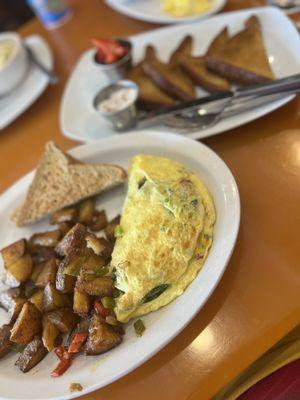 Spinach omelette with french toast and home fries.