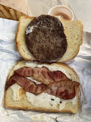 $9 sourdough burger.  2 slices of bread, cheese covering ~2/3rds, basically no spread, and enough bacon to cover half.  Ordered -tomato