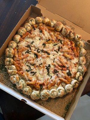 Penne Vodka Sauce Pizza with Garlic Knot Crust and Basil.