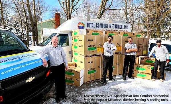 Burlington MA HVAC Specialists at Total Comfort Mechanical pose with the new stock of the popular Mitsubishi ductless AC unit...