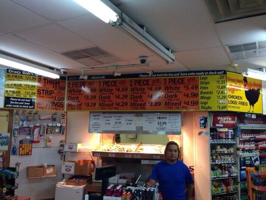 Menu board, window and friendly gas station employee.