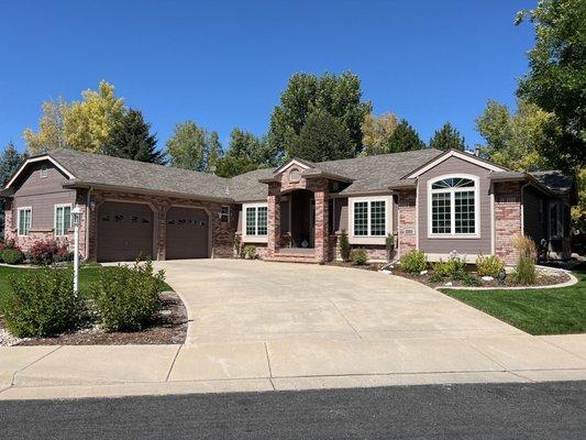 This home's roof perfectly complements its brick and siding exterior, providing reliable protection and seamless curb appeal.