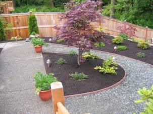 Transformed this backyard with winding gravel pathways held in place with recycled plastic edging boards.