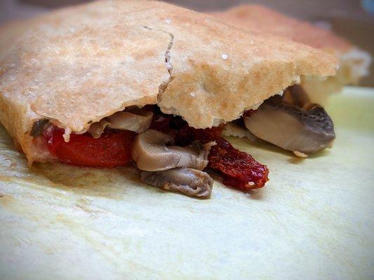 I can never take a photo of an intact panzerotti. (I can't delay those first bites!) Above: veggie panzerotti w/ mushrooms.