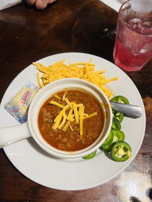 Chili with grated cheddar and fresh jalapeños.