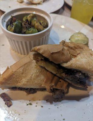 Steak and cheese sandwich with brussel sprouts