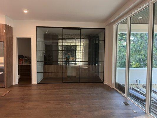 Glass enclosure creating a beautiful wine room.