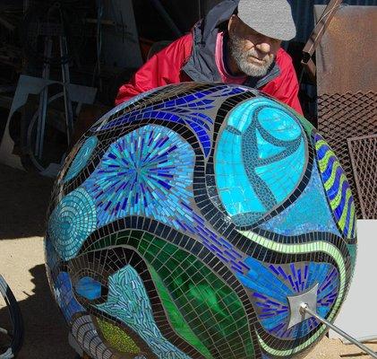 Moving the mosaic sphere out of the shop and into the living room.