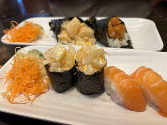 Back. - Spicy Scallop Hand Roll, Spicy Salmon Hand Roll, Front Spicy Scallop Nigiri Sushi, Salmon Nigiri Sushi.