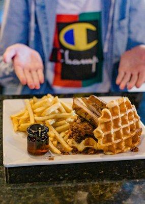 Shaggy Belgian Belgian crystalized waffles, homemade fried chicken topped with slow cooked pork belly, topped with maple syrup