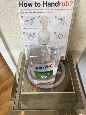 Hand sanitizer available adjacent to reception desk.