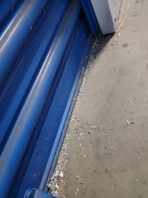 Wood chips and Metal Shavings infront of multiple garage doors. I've shown this to the Police as well.