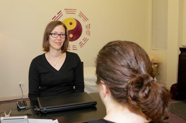 Lynn Palmgren, LAc interviewing patient