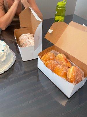 White powdered cream donuts, jelly and lemon filled sugar donuts and butter cream pound cake amazing.