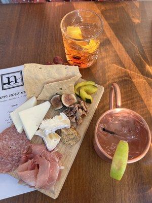 Charcuterie board with a Moscow mule and old fashioned