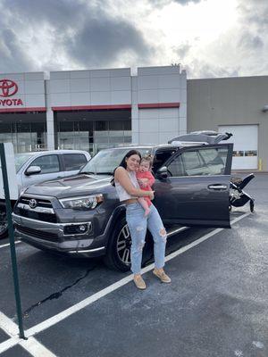 My wife and daughter in front of our new car!