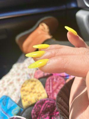 side view of neon yellow acrylic nails