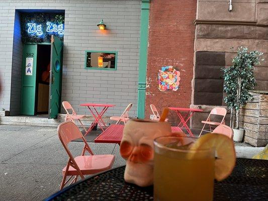 Outdoors. Frozen strawberry daiquiri and a lemony cocktail.