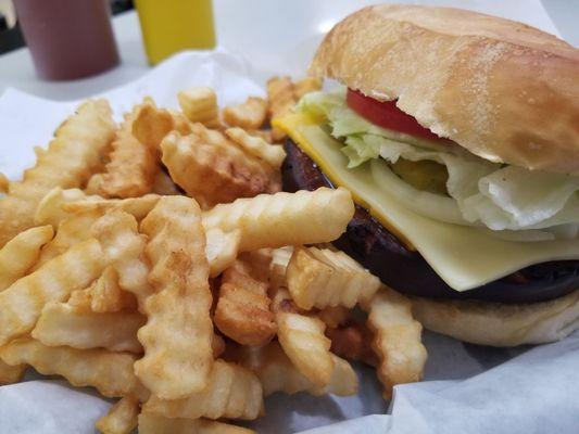 Thick-cut fried bologna sandwich with everything, plus a side of French fries.