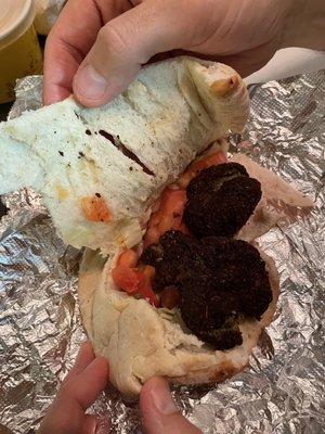 This was the falafel sandwich we just got. Where is the lettuce and tomato? It was nearly forgotten.   Never again.