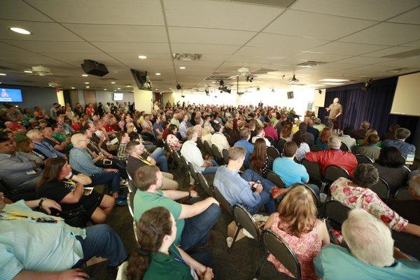 CEO/Founder, Del Walmsley, leads a presentation after around 500 investors toured 8 member-owned apartment complexes.