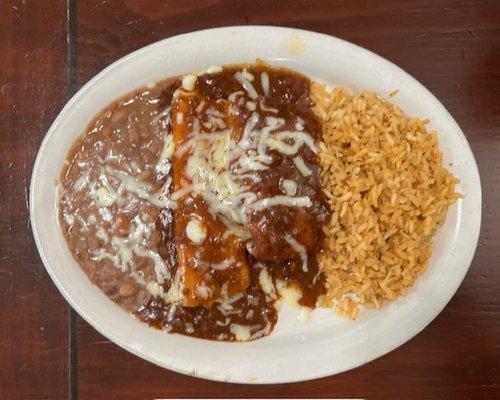 Tamale and a cheese enchilada covered in a delicious chili gravy.