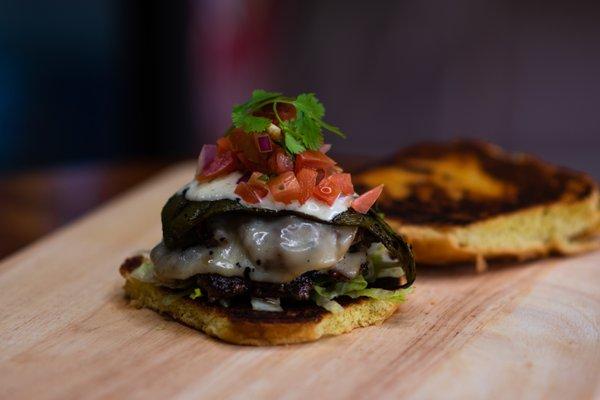 Beach house- 2 Pattie's, roasted green chili, smoked mozzarella, pico de gallo, & jalapeño ranch.