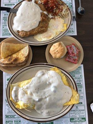 Country fried steak with toast and a country omelette with a biscuit.