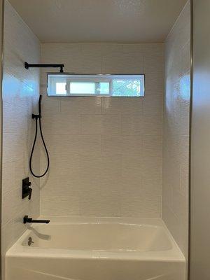 Completely tore out and rebuilt shower with new tile and cast-iron tub.