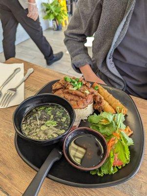 Rice plate with pork and egg rolls