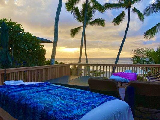 Setting up for tropical sunset couples massage