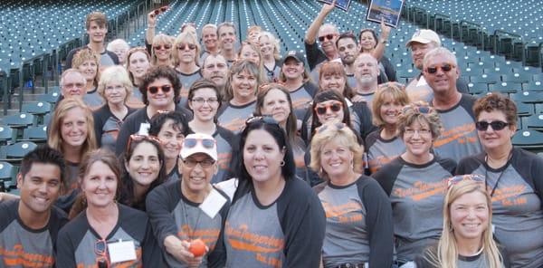 The Tangerine Team celebrates at SafeCo Field, receiving Puget Sound Business Journal's bronze award for Best Places to Work