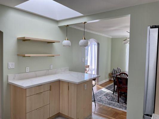 Open shelves replaced upper cabinet that previously blocked out skylight.