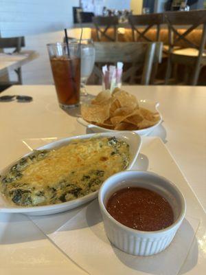 Spinach artichoke dip with a slightly spicy cilantro based salsa and fresh, warm chips.