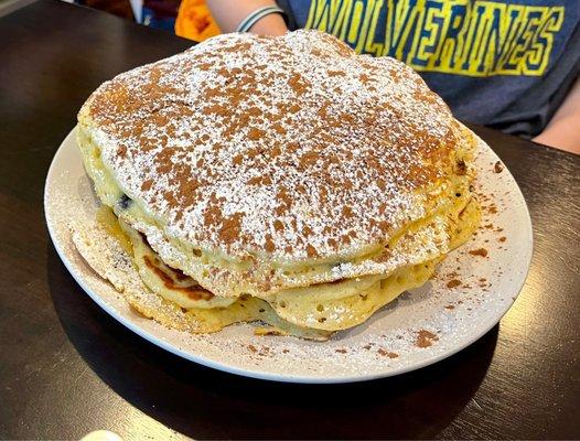 Three very large chocolate chip pancakes.