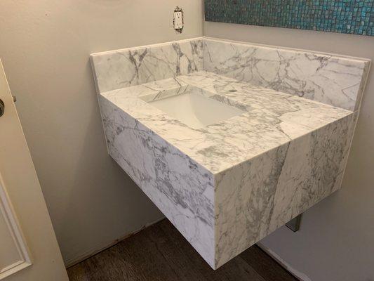 Floating powder vanity made out of marble